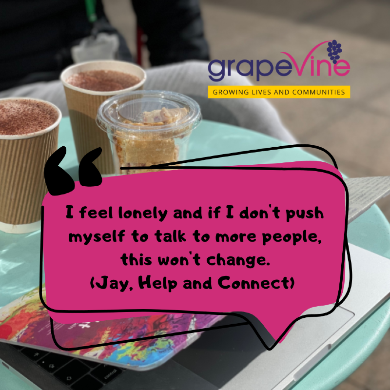 Three cups - two containing hot chocolate and one with flapjacks pieces - sit on a white table with a pink stickered laptop. It is a sunny day and the table they are on is outside. Chairs can be seen too.
