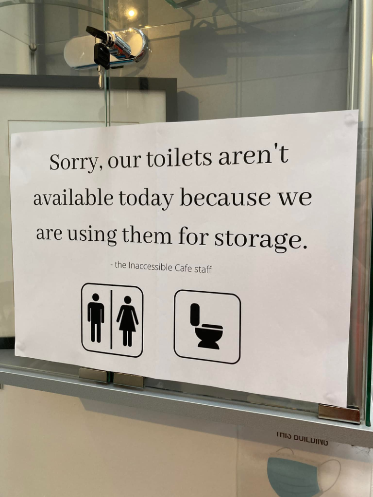 A sign says disabled toilets are out of order because they are being used for storage. A common issue for disabled people trying to access venues.