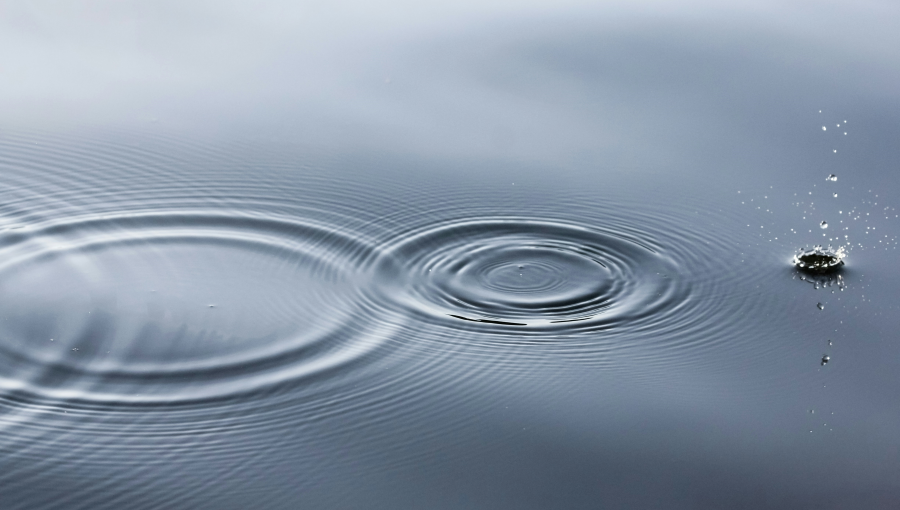 Stock photo by Linus Nyland on Unsplash shows two ripples on calm water and one splash.