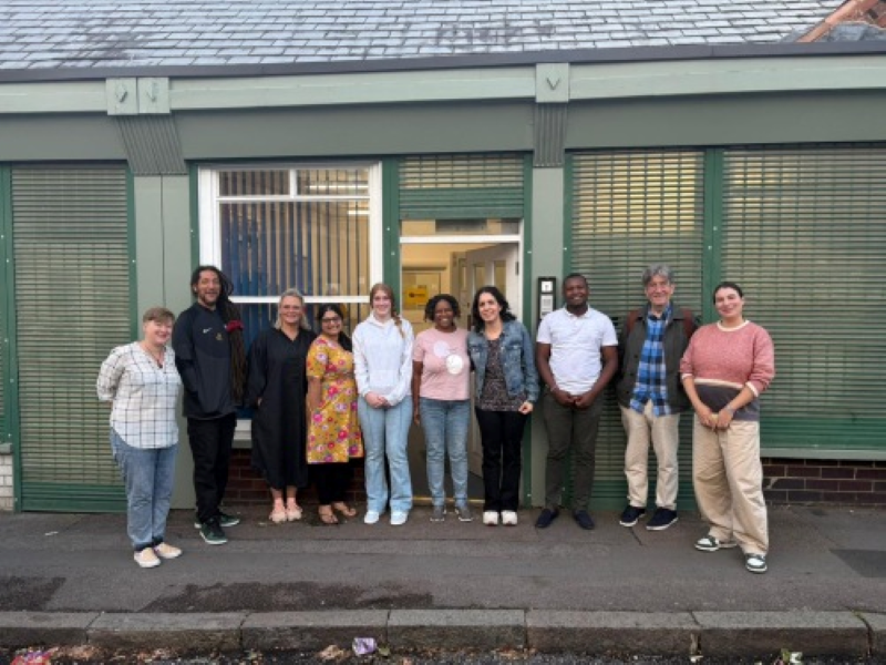 A group of ten men and women stand outside Grapevine offices in Coventry. They are different ages and ethnicities. They are the core team for Connecting for Good.