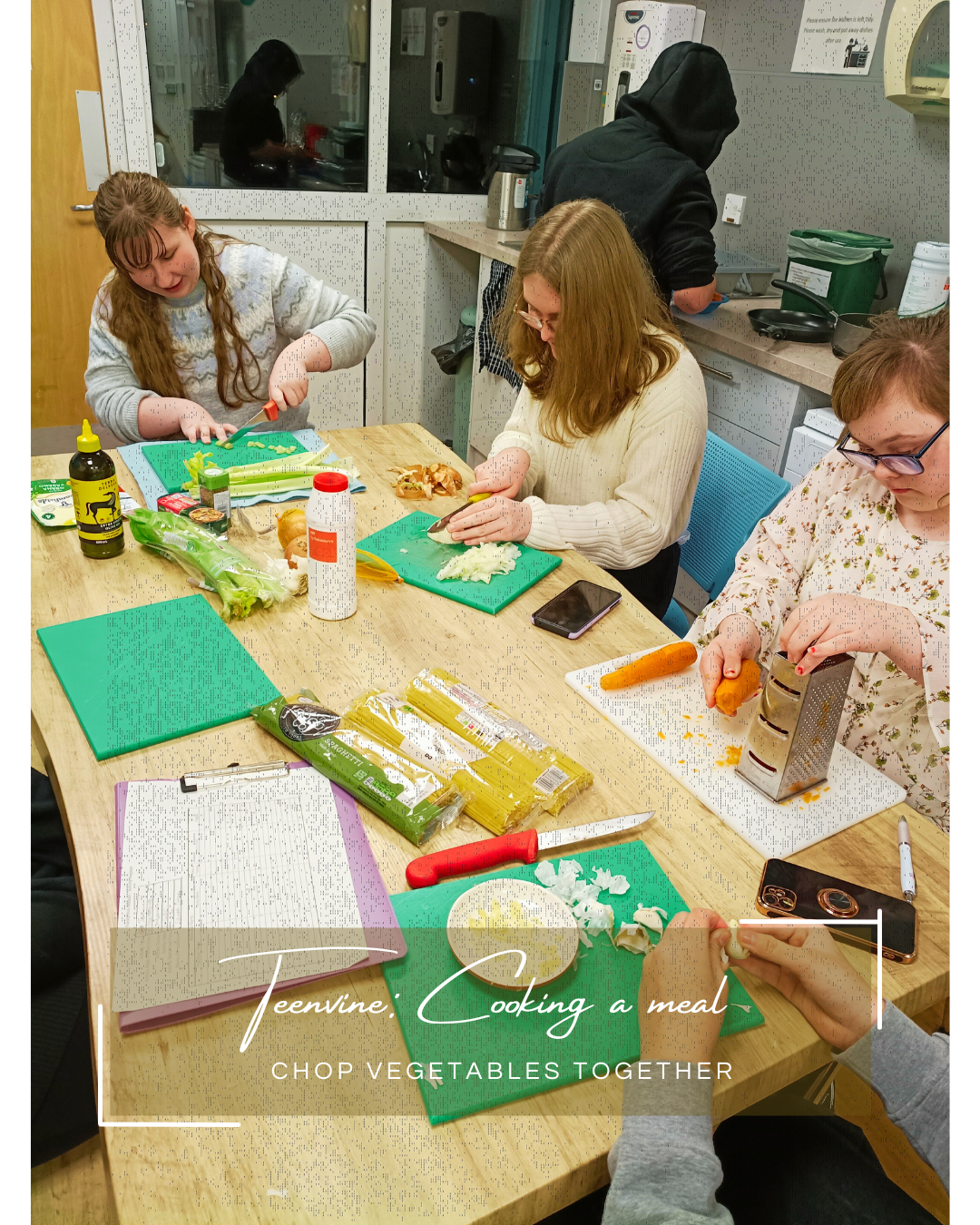 Three young disabled girls sit around a community kitchen table chopping vegetables and chatting.