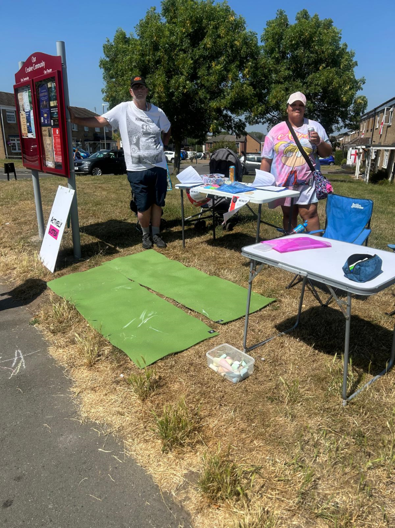 The Chair of Friends of Grove Farm, Paul, with vice chair Jessykah at a community listening event over the summer. They stand next to the new noticeboard the group jointly manages with Nuneaton’s Abbey Theatre.