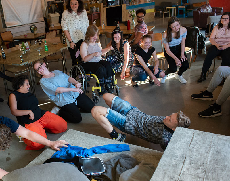 A group of young people of all abilities parties together in a local coffee shop.
