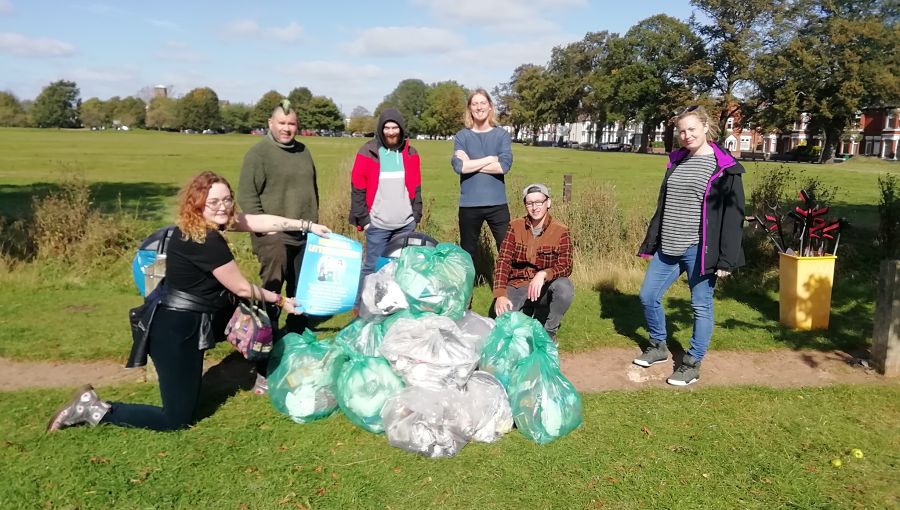 A group of litter pickers with the rubbish they have collected in their community