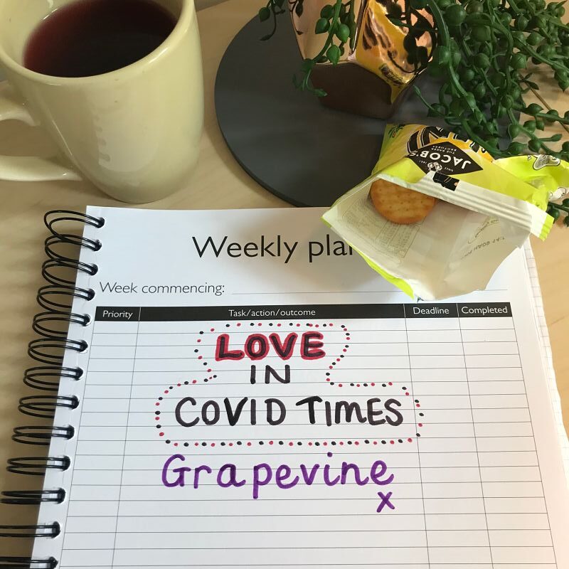 Love in Covid Times written on a piece of paper