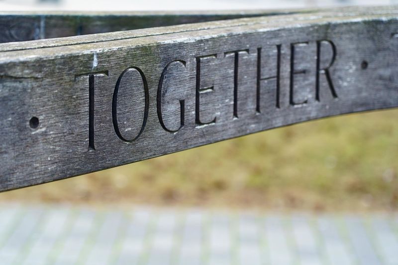 A wooden bench reads "Together"